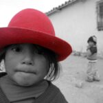 black and white photo with girl with red hat