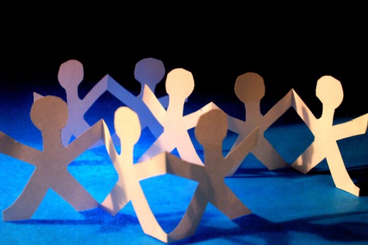 cut-out people holding hands