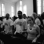 photo of strikers and allies in church praying for workers