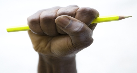 hand fisted and holding pencil