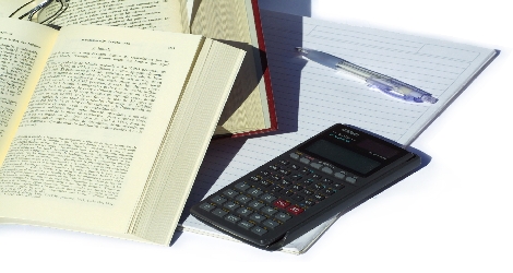photo of books, paper and calculator