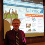 photo of patrick heery with projection of Unbound at launch