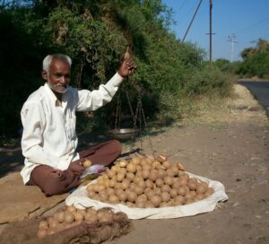 photo of a man selling potatoes