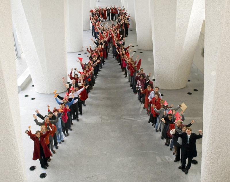 people lined up in shape of AIDS ribbon