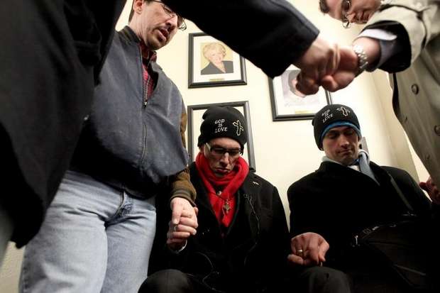 Rev. Maurice "Bojangles" Blanchard and his partner, Dominique James, joined by supporters as they pray and nonviolently protest marriage inequality